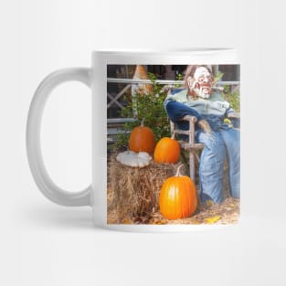 Halloween Mannequin in with ugly mask chair outside beside three large orange pumpkins Mug